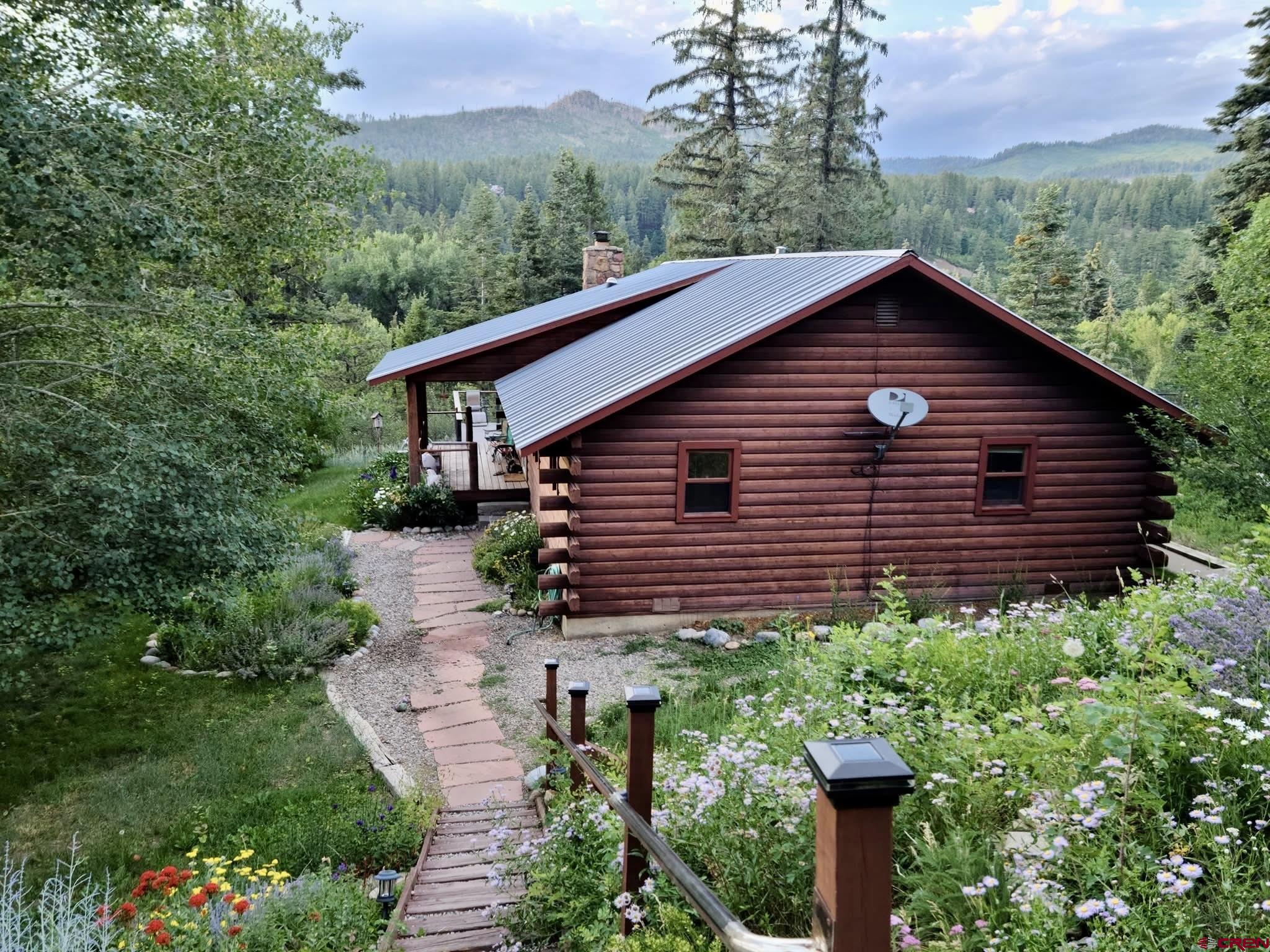 511 High Trails Drive Durango, CO 81301 - Photo 41 of 45 a view of a house with a small yard plants and large tree