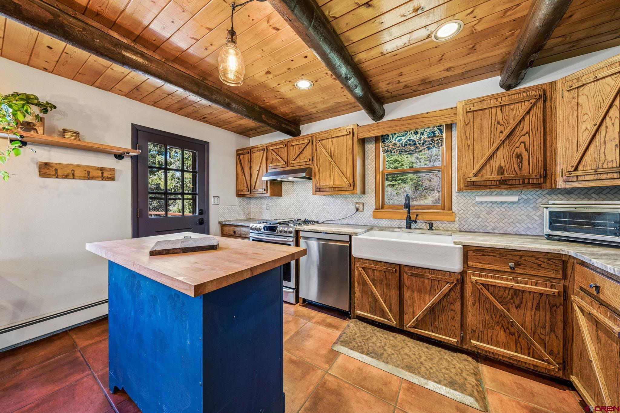 511 High Trails Drive Durango, CO 81301 - Photo 10 of 45 a kitchen with a stove sink and cabinets
