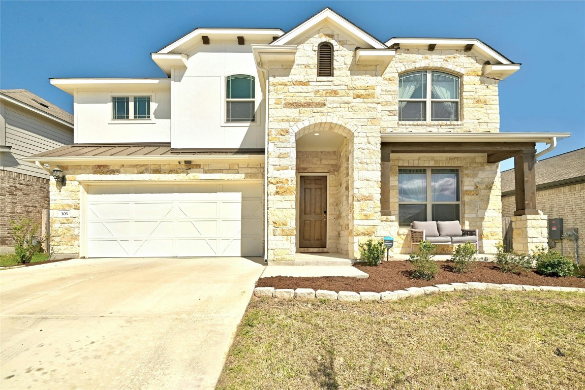 303 Cherrystone Loop Buda, TX 78610 - Photo 1 of 1 a front view of a house with a yard
