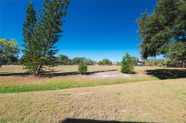 a front view of house with yard and swimming pool