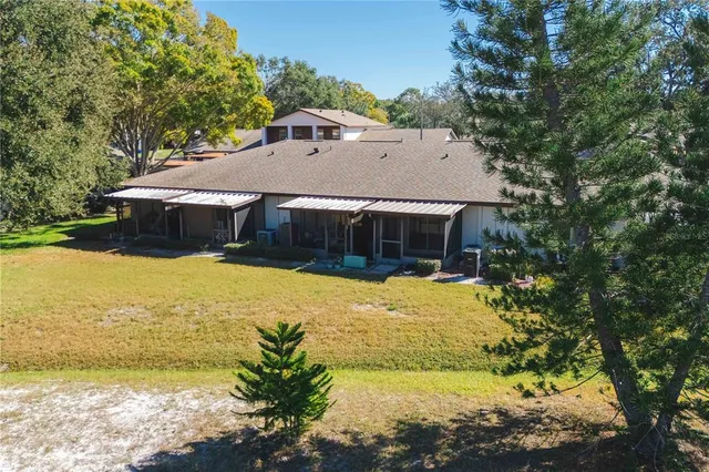 a view of a porch with a table and chairs