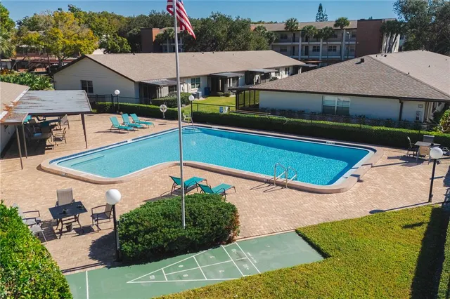 an outdoor space with pool and furniture
