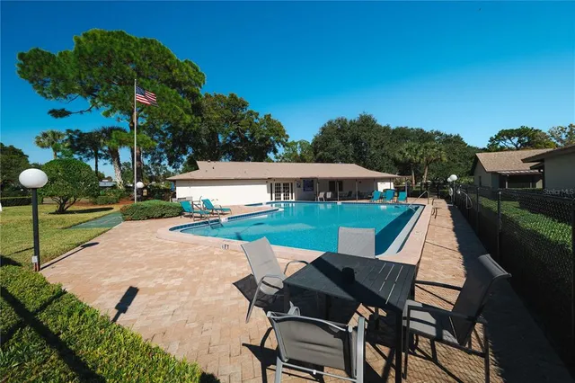 a view of swimming pool with chairs