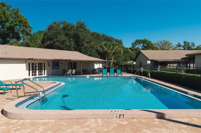 a view of a house with garden space and sitting area