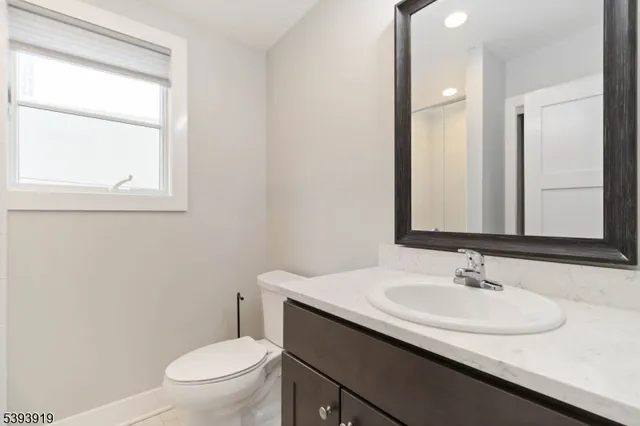 a bathroom with a sink toilet and a mirror