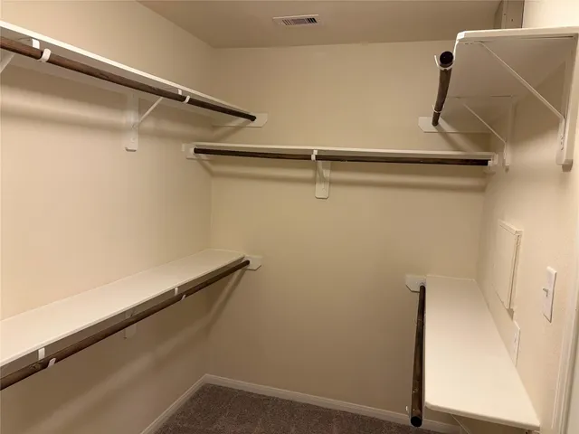 a view of backyard with wooden fence