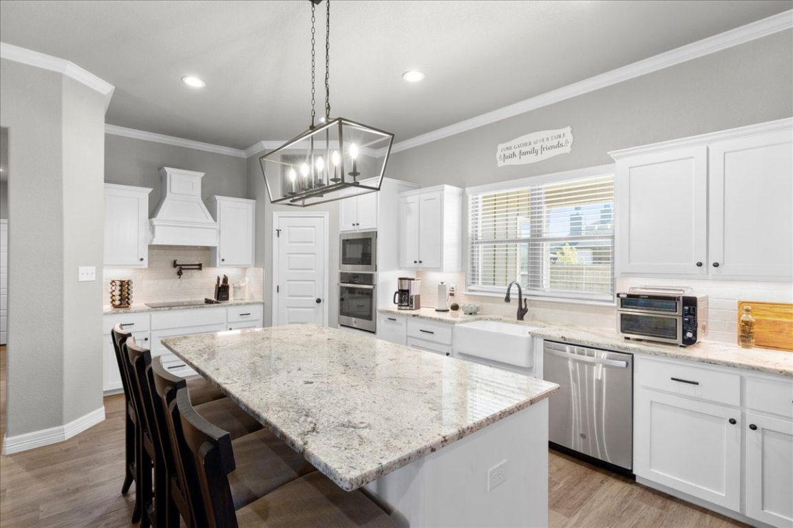 3810 Green Tree Loop Temple, TX 76502 - Photo 11 of 40 a large kitchen with kitchen island a table and chairs in it