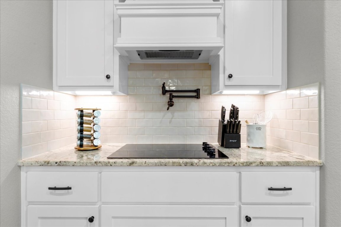 3810 Green Tree Loop Temple, TX 76502 - Photo 12 of 40 a kitchen with granite countertop white cabinets and a sink