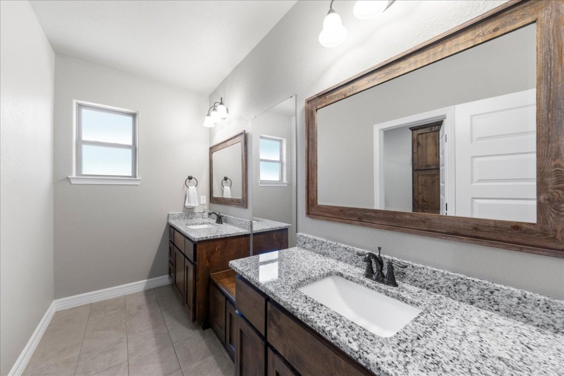 3810 Green Tree Loop Temple, TX 76502 - Photo 15 of 40 a bathroom with a granite countertop sink double and mirror