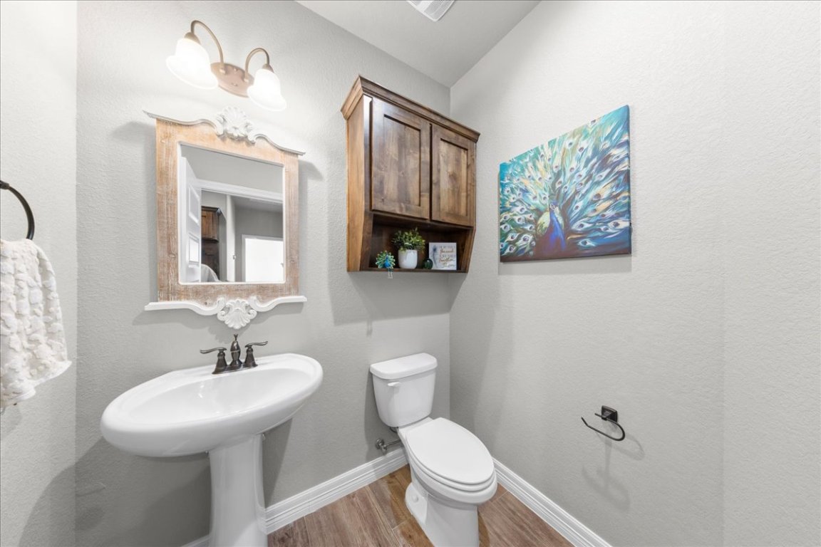 3810 Green Tree Loop Temple, TX 76502 - Photo 19 of 40 a bathroom with a toilet sink and mirror