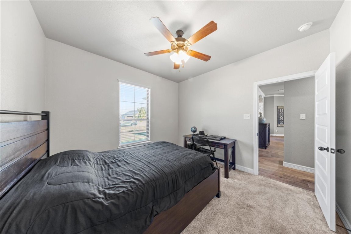 3810 Green Tree Loop Temple, TX 76502 - Photo 21 of 40 Carpeted bedroom featuring baseboards and a ceiling fan