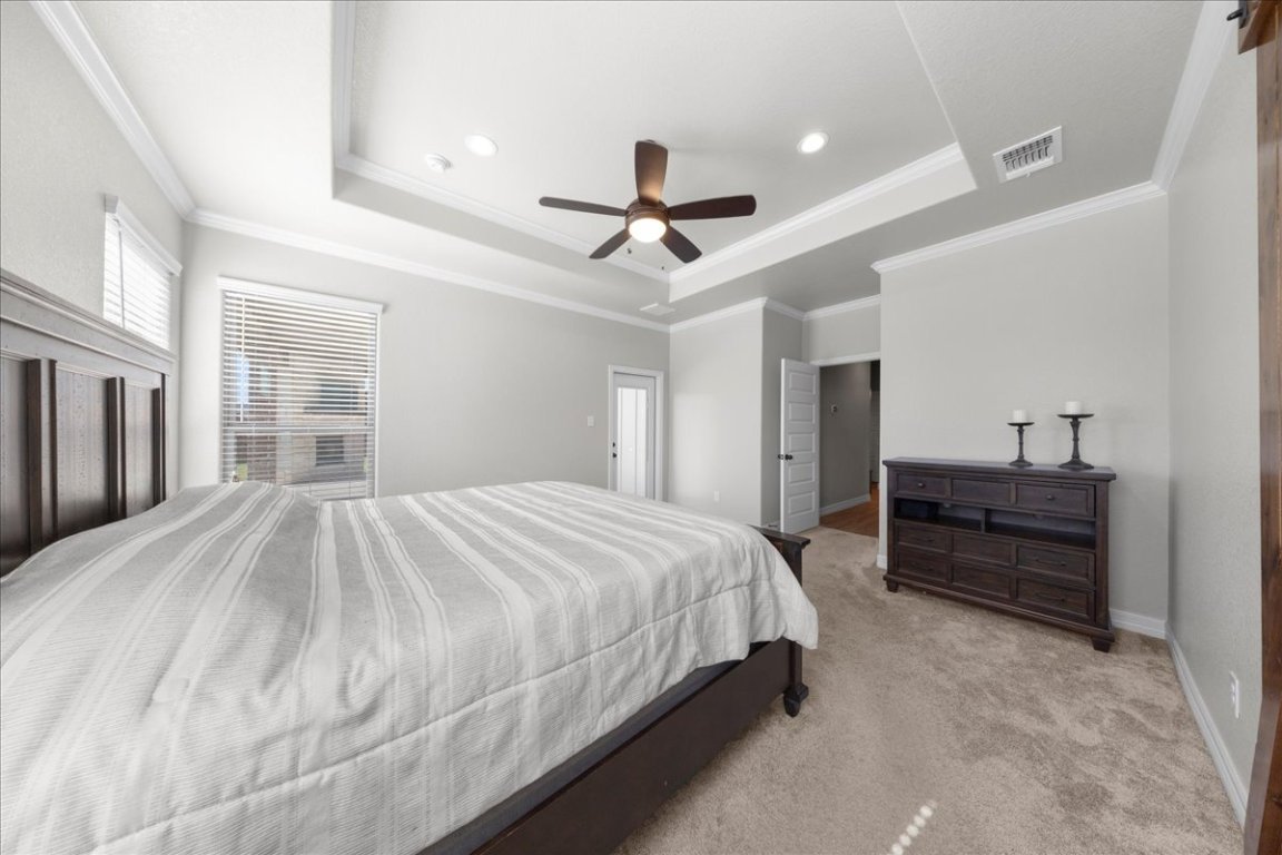 3810 Green Tree Loop Temple, TX 76502 - Photo 25 of 40 a bedroom with a bed and a chandelier