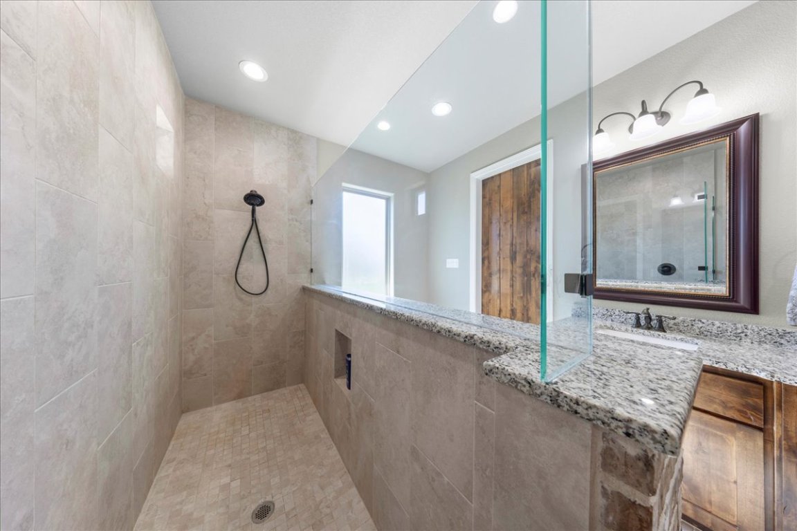 3810 Green Tree Loop Temple, TX 76502 - Photo 29 of 40 a bathroom with a granite countertop sink mirror and vanity