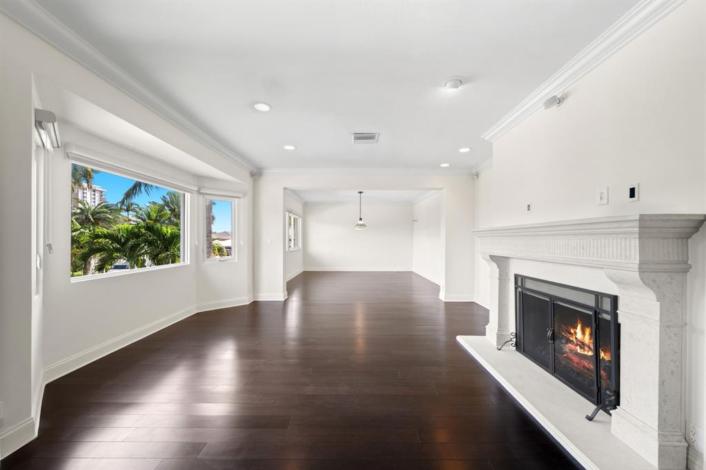 3741 Northeast 31st Avenue Lighthouse Point, FL 33064 - Photo 15 of 40 a view of empty room with wooden floor and fireplace