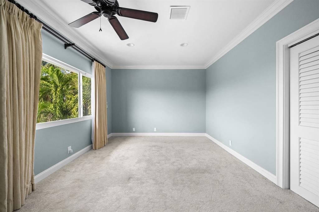 3741 Northeast 31st Avenue Lighthouse Point, FL 33064 - Photo 24 of 40 an empty room with a window and a ceiling fan