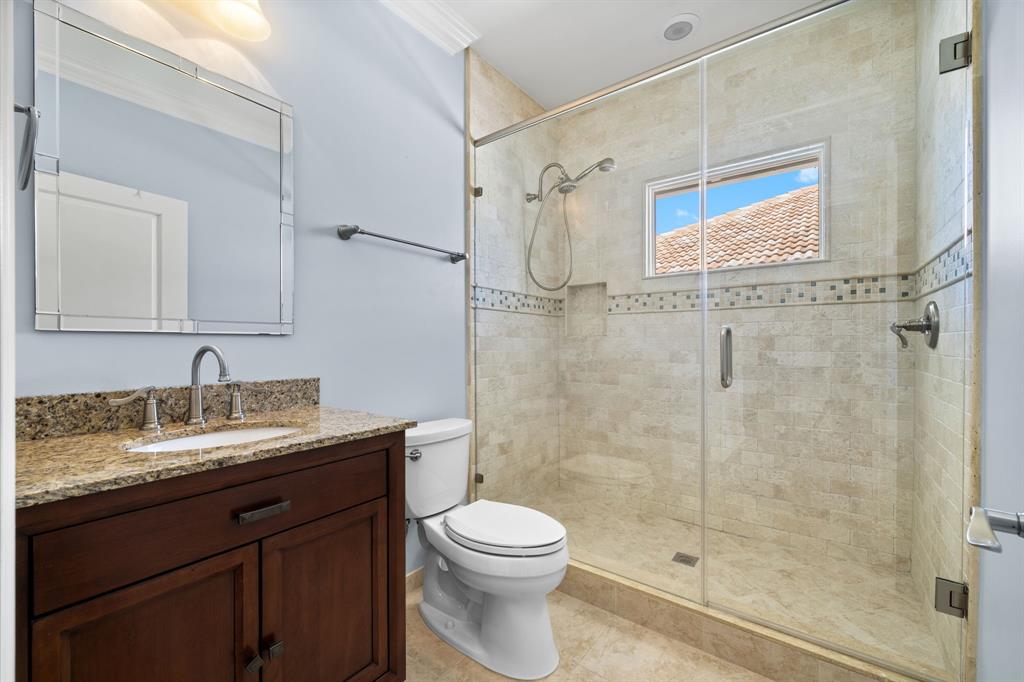 3741 Northeast 31st Avenue Lighthouse Point, FL 33064 - Photo 27 of 40 a bathroom with a granite countertop sink a toilet and shower