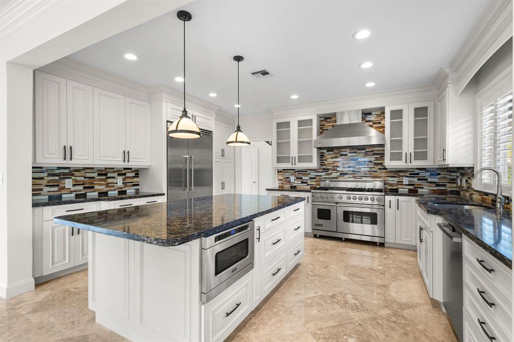 3741 Northeast 31st Avenue Lighthouse Point, FL 33064 - Photo 5 of 40 a kitchen with stainless steel appliances granite countertop a sink stove and cabinets