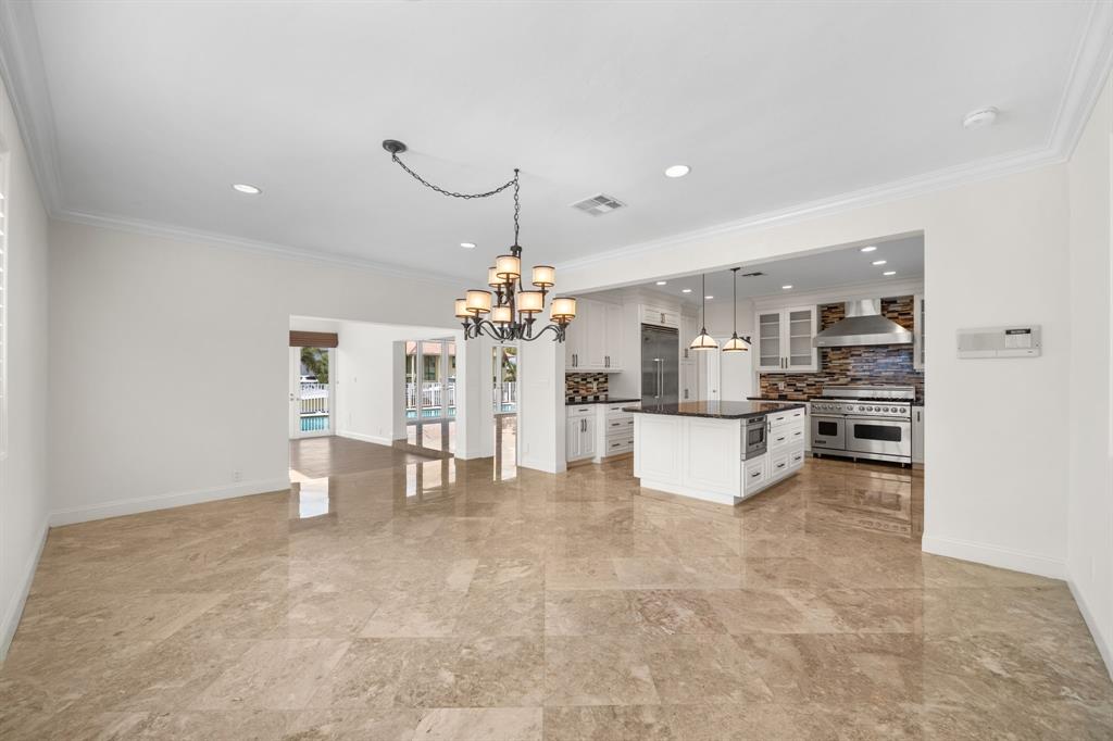 3741 Northeast 31st Avenue Lighthouse Point, FL 33064 - Photo 8 of 40 a view of a kitchen with a refrigerator and a fireplace