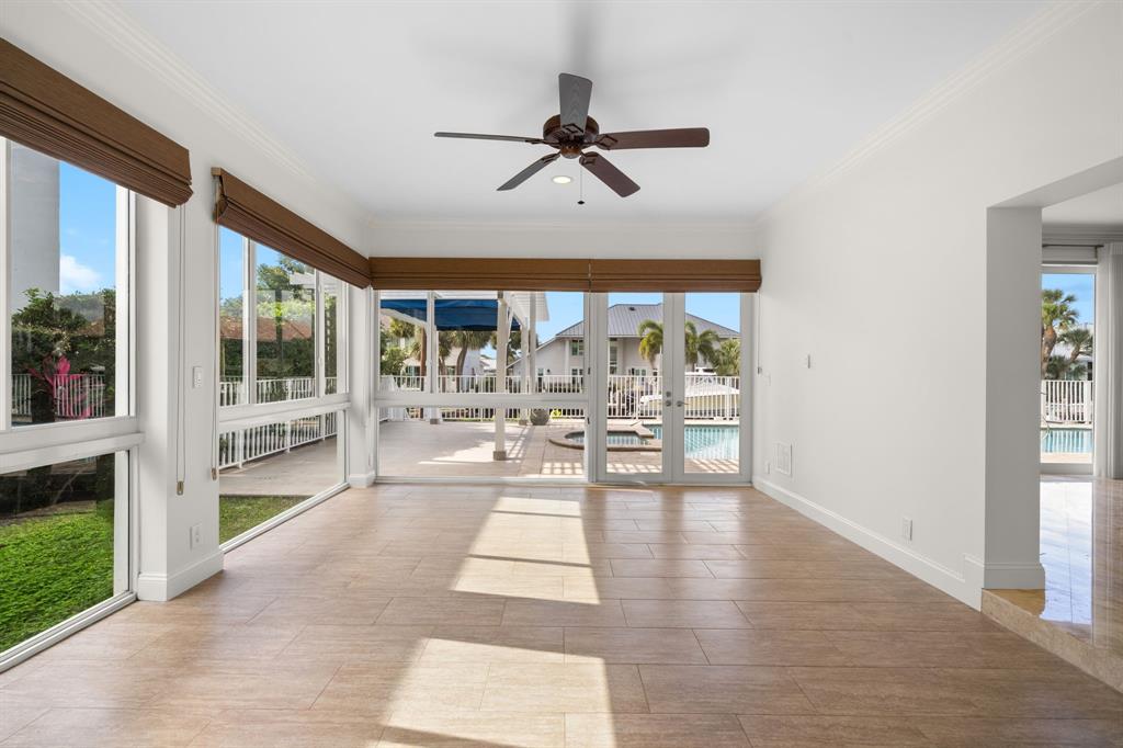 3741 Northeast 31st Avenue Lighthouse Point, FL 33064 - Photo 10 of 40 a view of a living room and kitchen with a floor to ceiling window