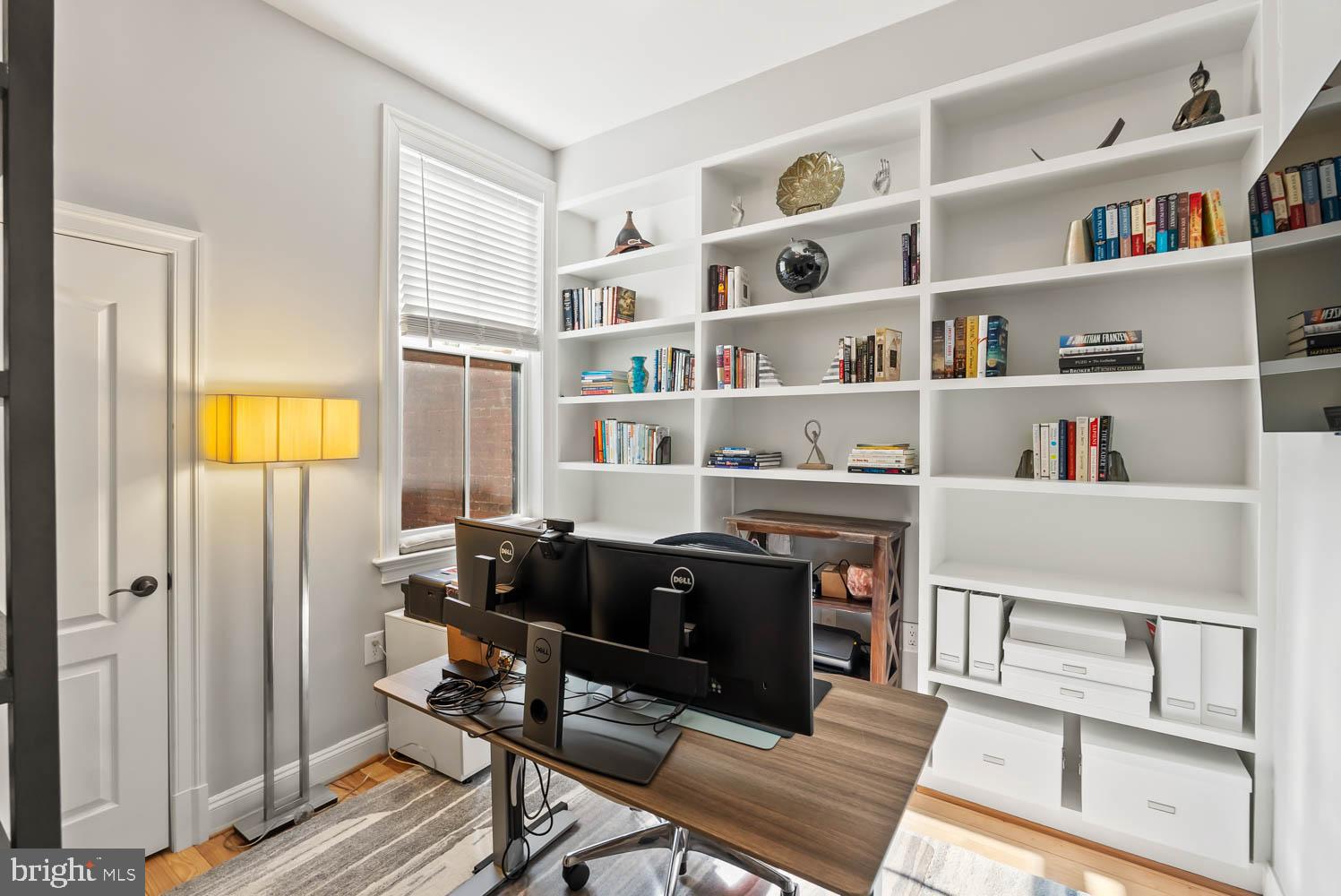 1224 R Street Northwest, Unit 2 Washington, DC 20009 - Photo 13 of 36 a view of a workspace with furniture and a bookshelf