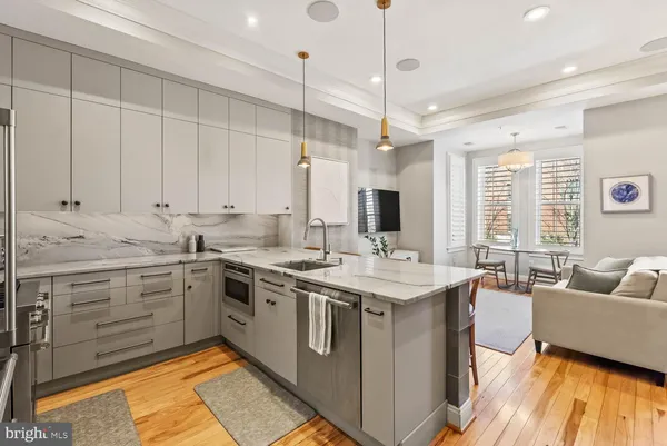 a kitchen with stainless steel appliances granite countertop a sink and stove
