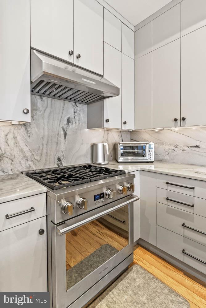 1224 R Street Northwest, Unit 2 Washington, DC 20009 - Photo 9 of 36 a kitchen with stove top oven and cabinets