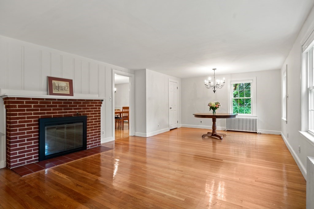 11 Wheelock Road Wayland, MA 01778 - Photo 4 of 24 a view of an empty room with a fireplace and a window