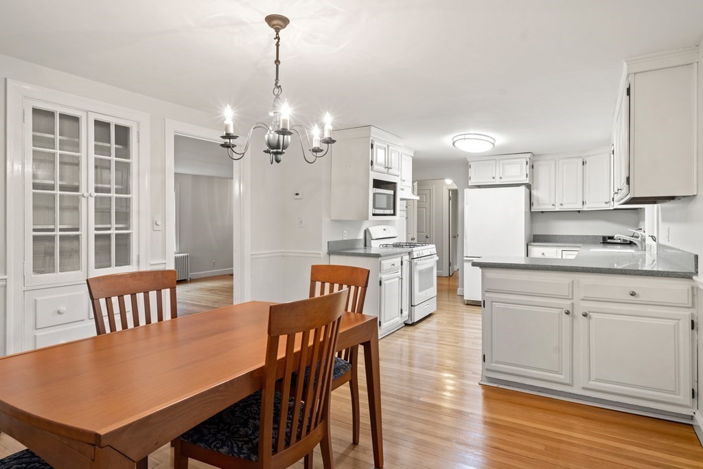 11 Wheelock Road Wayland, MA 01778 - Photo 7 of 24 a view of a dining room with furniture and wooden floor