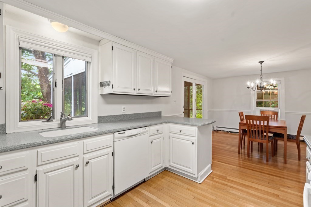 11 Wheelock Road Wayland, MA 01778 - Photo 9 of 24 a kitchen with granite countertop cabinets a dining table and chairs