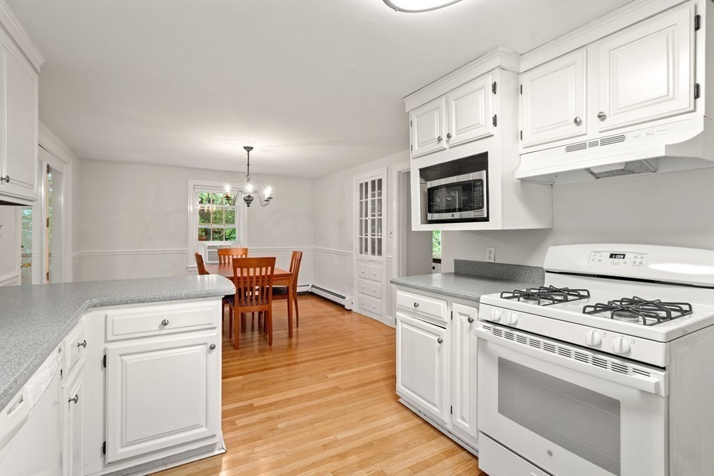 11 Wheelock Road Wayland, MA 01778 - Photo 10 of 24 a kitchen with white cabinets and appliances
