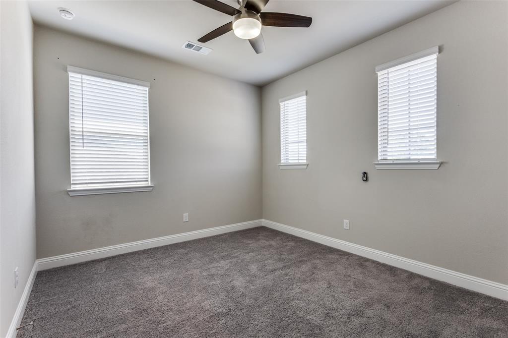 2912 Inn Kitchen Way McKinney, TX 75071 - Photo 14 of 29 an empty room with a window and a fan