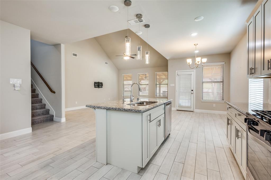2912 Inn Kitchen Way McKinney, TX 75071 - Photo 4 of 29 a kitchen with stainless steel appliances granite countertop a stove and a refrigerator
