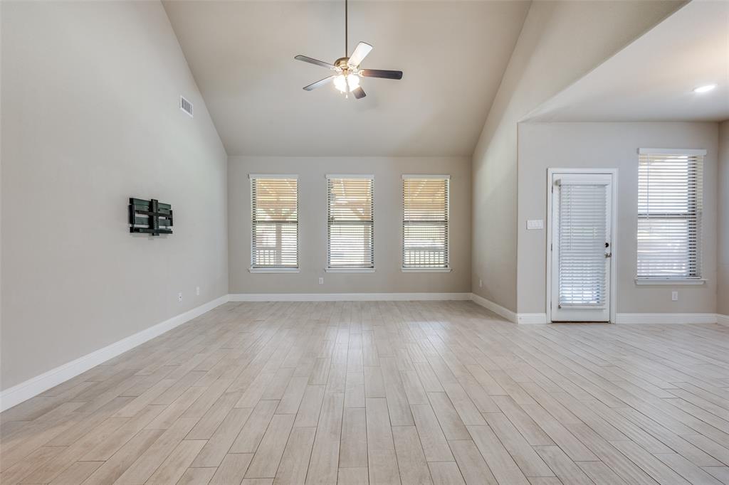 2912 Inn Kitchen Way McKinney, TX 75071 - Photo 5 of 29 a view of an empty room with a window and wooden floor