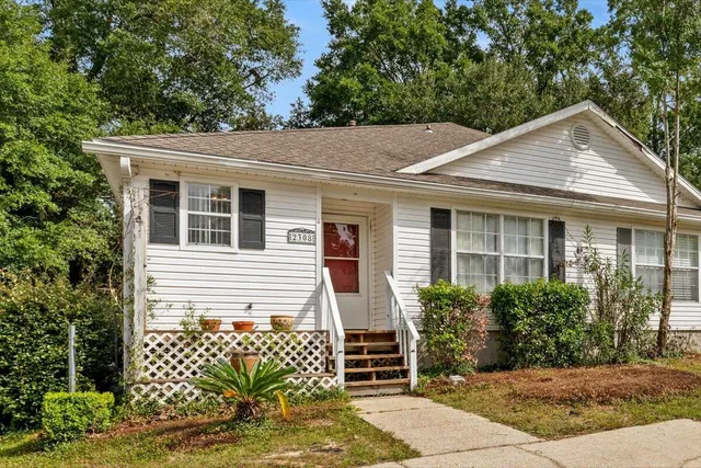 a front view of a house with a garden