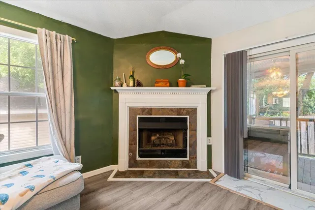 a living room with a fireplace and a large window