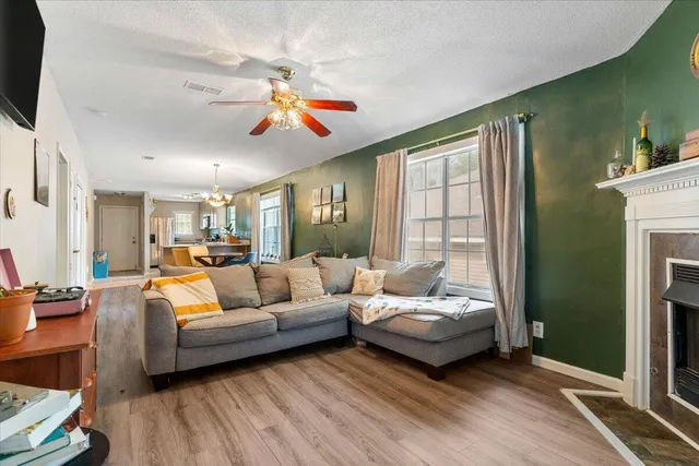 a living room with furniture a fireplace and a flat screen tv