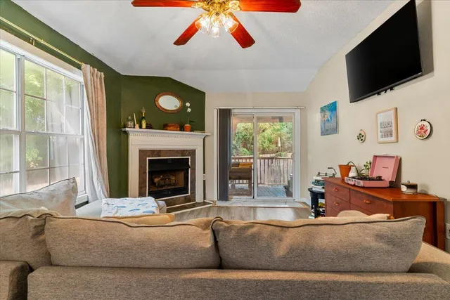 a living room with fireplace furniture and a flat screen tv