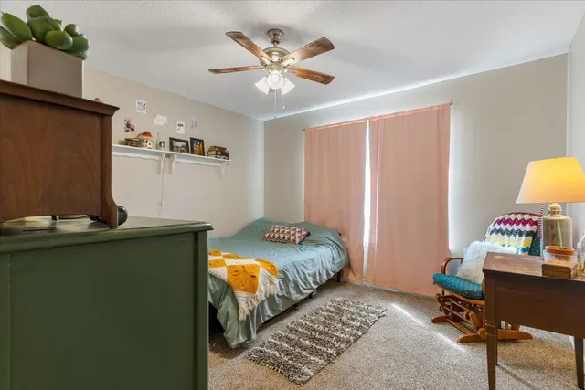 a bedroom that has a bed and a table in it