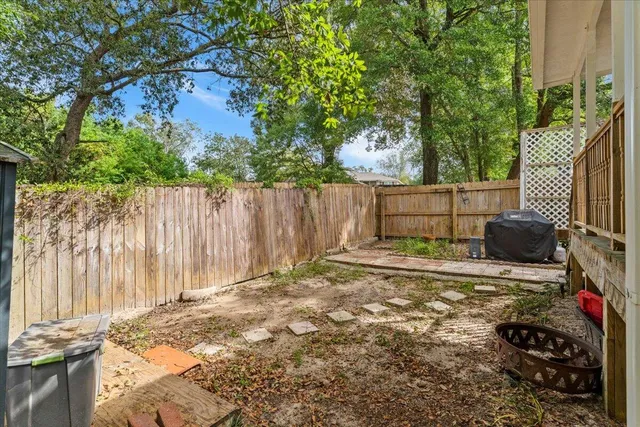 a white house covered with tall trees