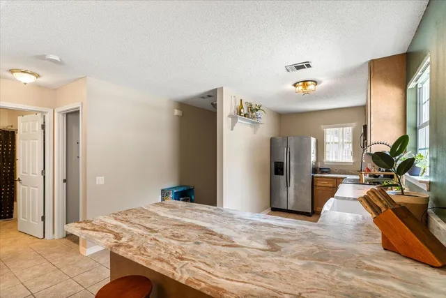 a bedroom with a bed dresser and a large mirror