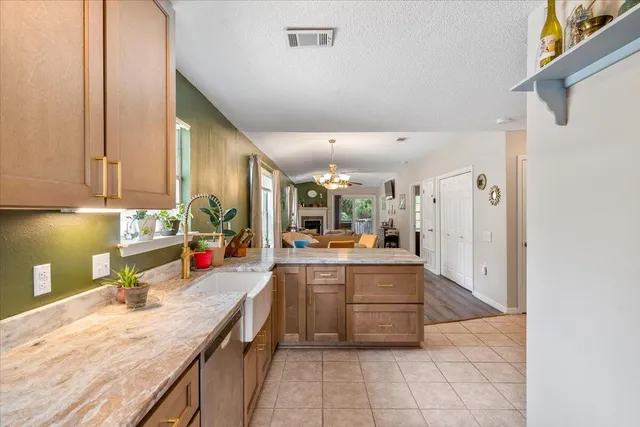 a kitchen with stainless steel appliances granite countertop a sink and cabinets