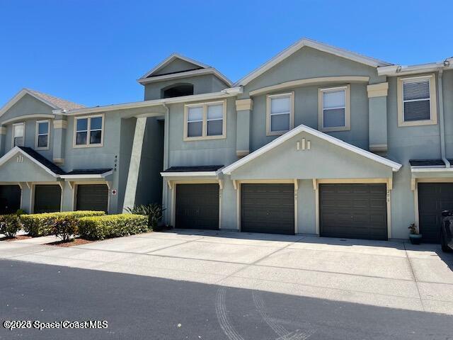 4106 Meander Place, Unit 208 Rockledge, FL 32955 - Photo 1 of 19 a front view of a house with a yard and garage