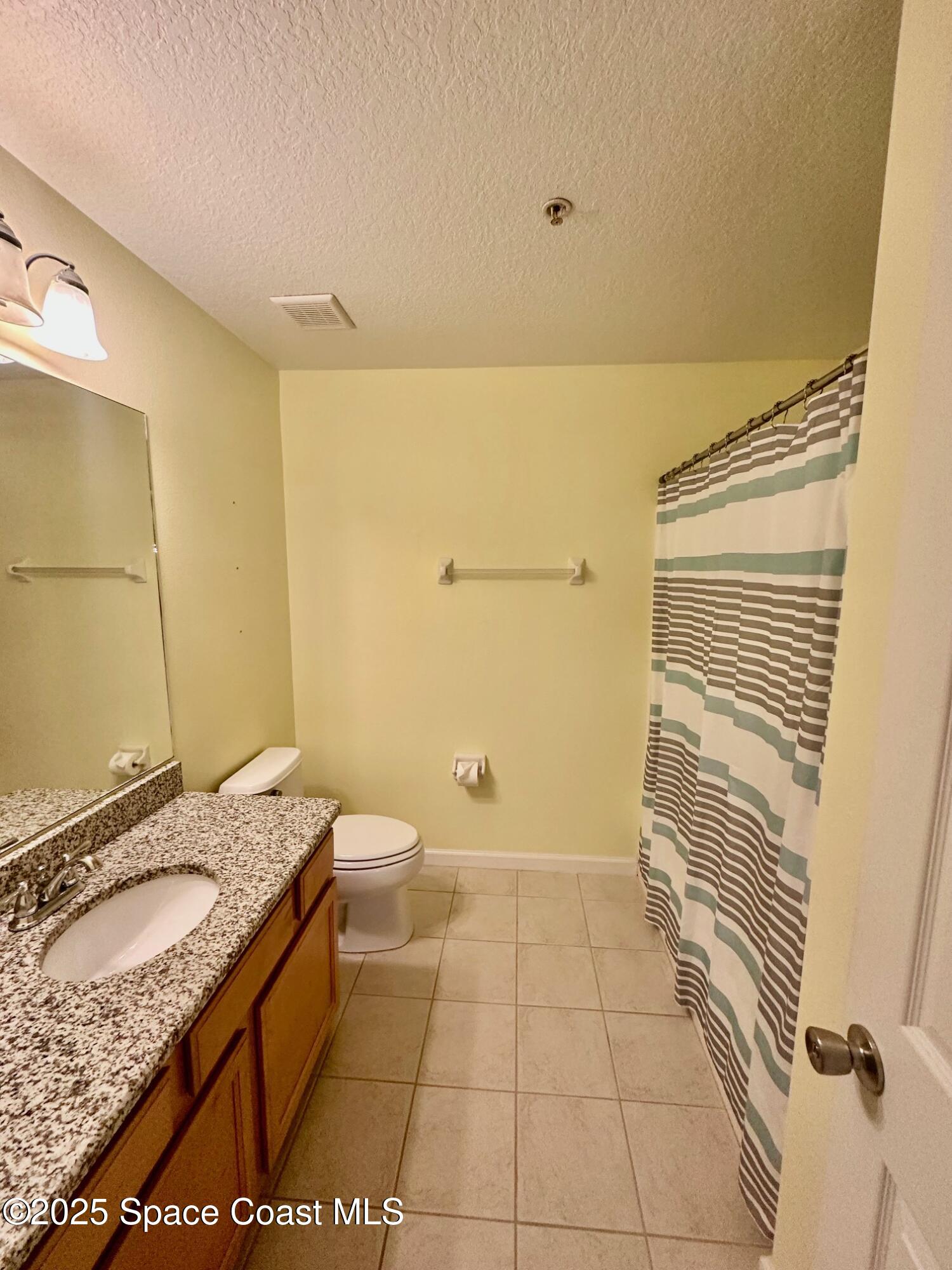 4106 Meander Place, Unit 208 Rockledge, FL 32955 - Photo 13 of 19 a bathroom with a granite countertop sink and a mirror