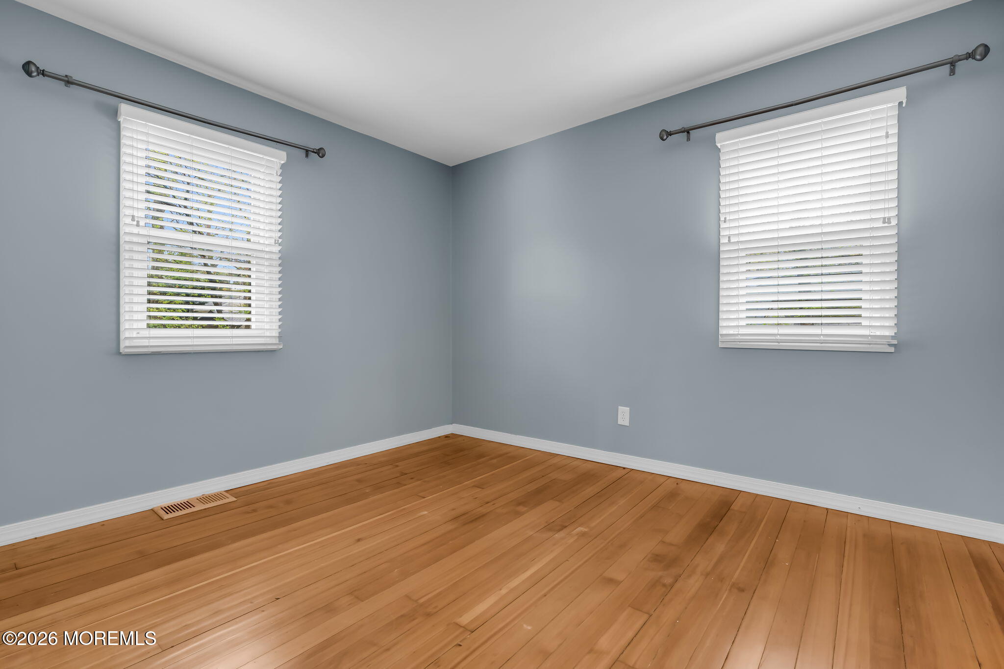 593 Beach Plum Road Brick, NJ 08723 - Photo 23 of 38 a view of an empty room with wooden floor and a window
