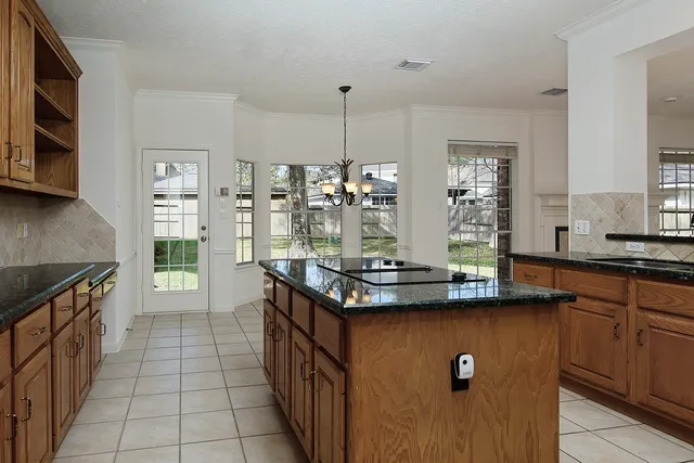 a kitchen with stainless steel appliances granite countertop a sink stove and cabinets