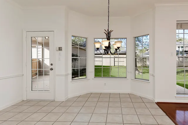 a view of an entryway with window and chandelier