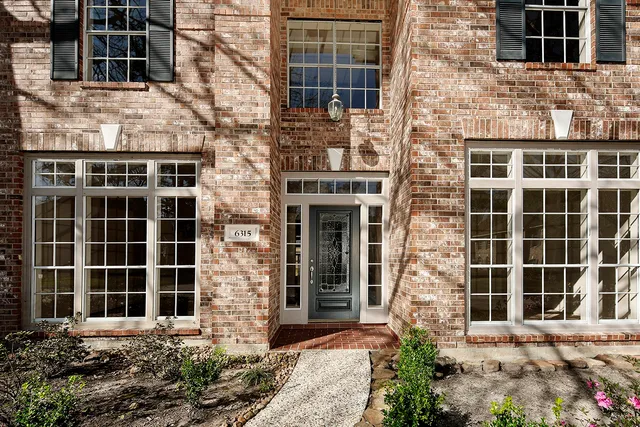 a front view of a building with a garden