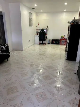 a room with gym equipment and a flat screen tv