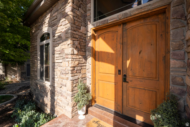 687 South 2080th Street East Springville, UT 84663 - Photo 125 of 149 Double wood-panel entry doors with a black hardware set, framed by a stone facade