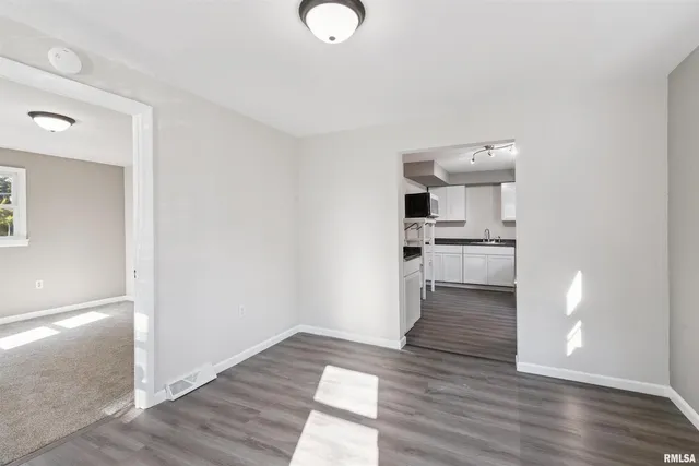 a view of a kitchen with wooden floor and a sink